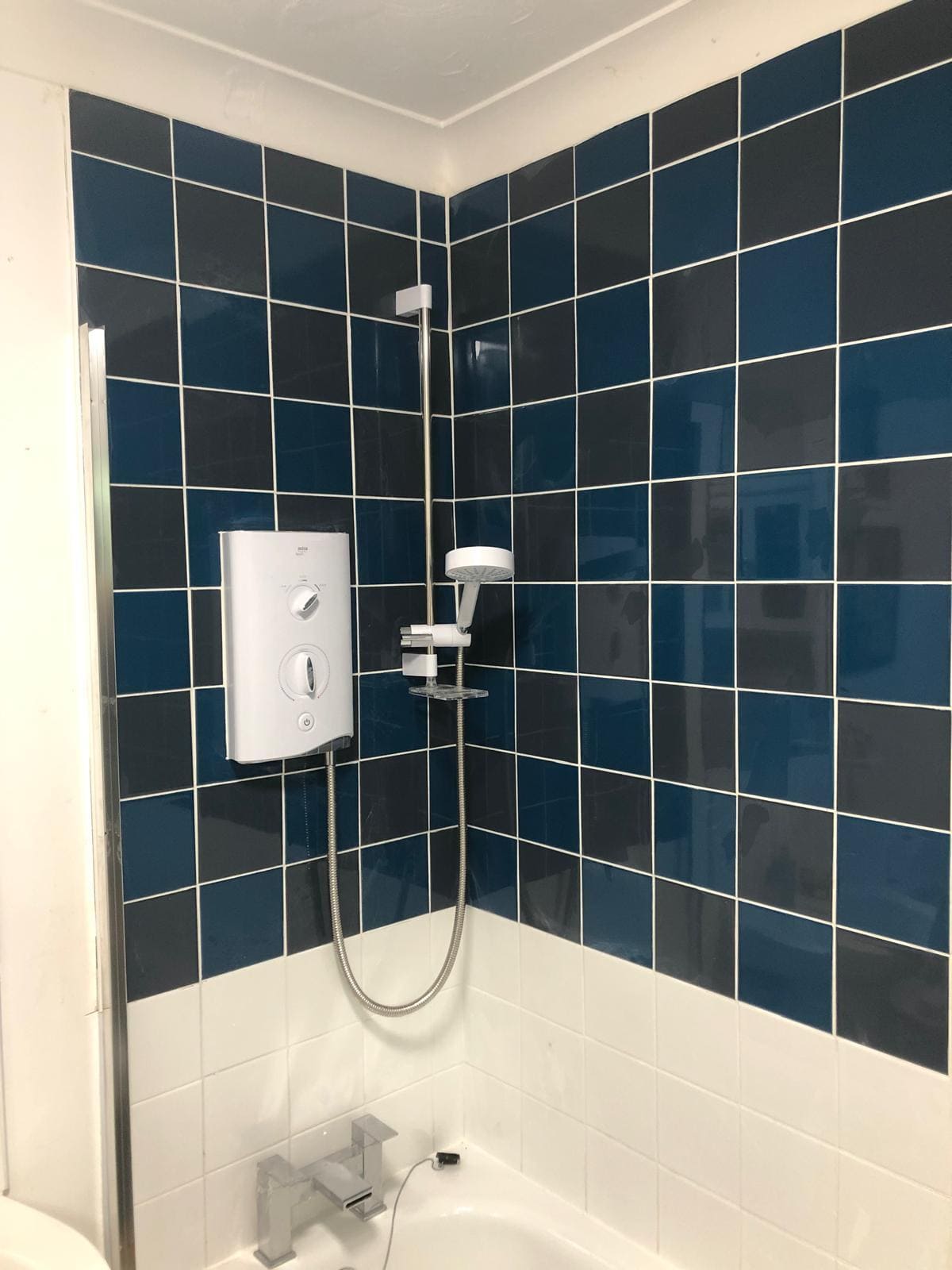 Completed London bathroom installation by Refurb Squad with walk-in shower, tiled walls and modern brassware