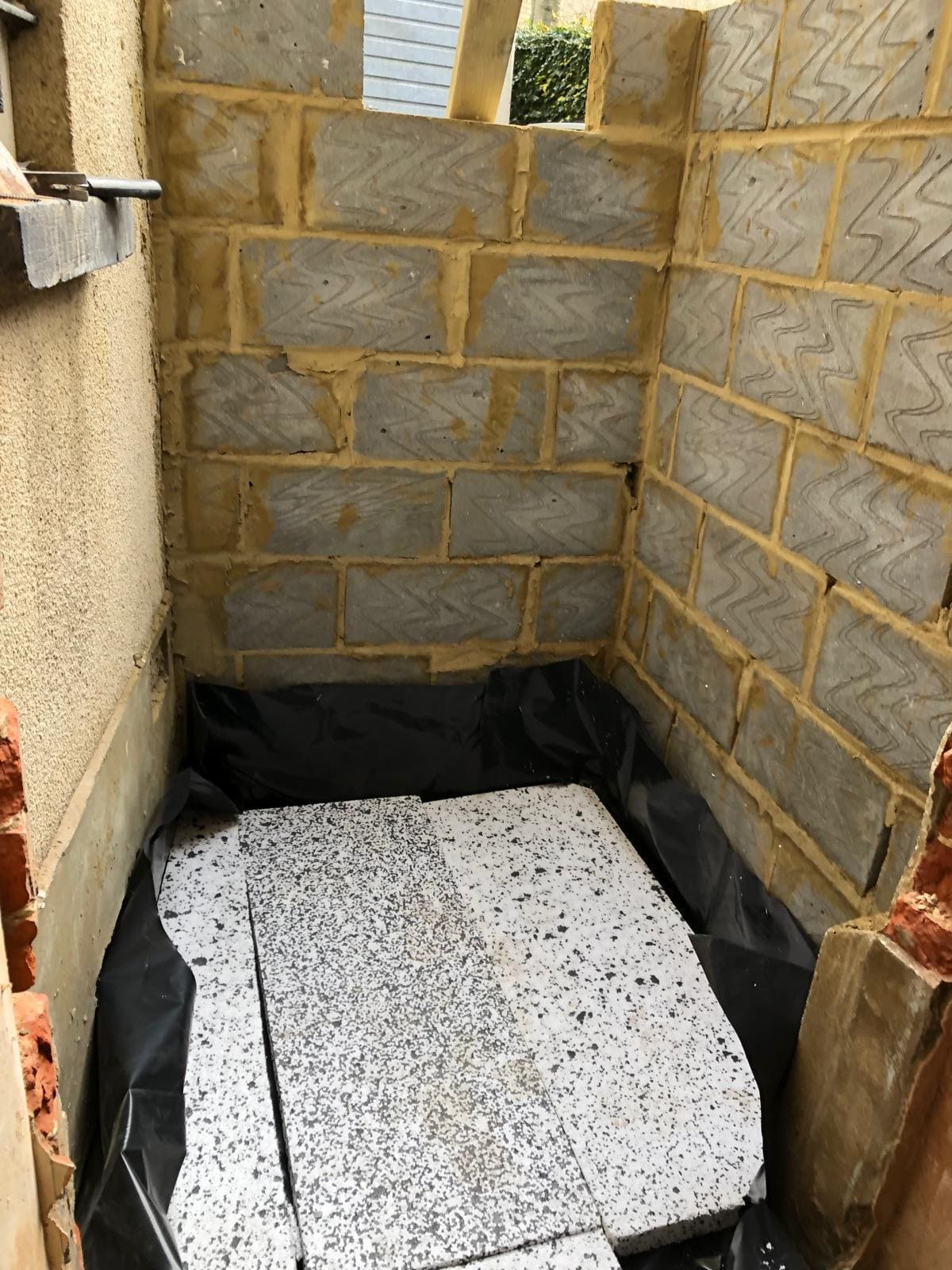 Blockwork under construction on a single-storey London rear house extension by Refurb Squad