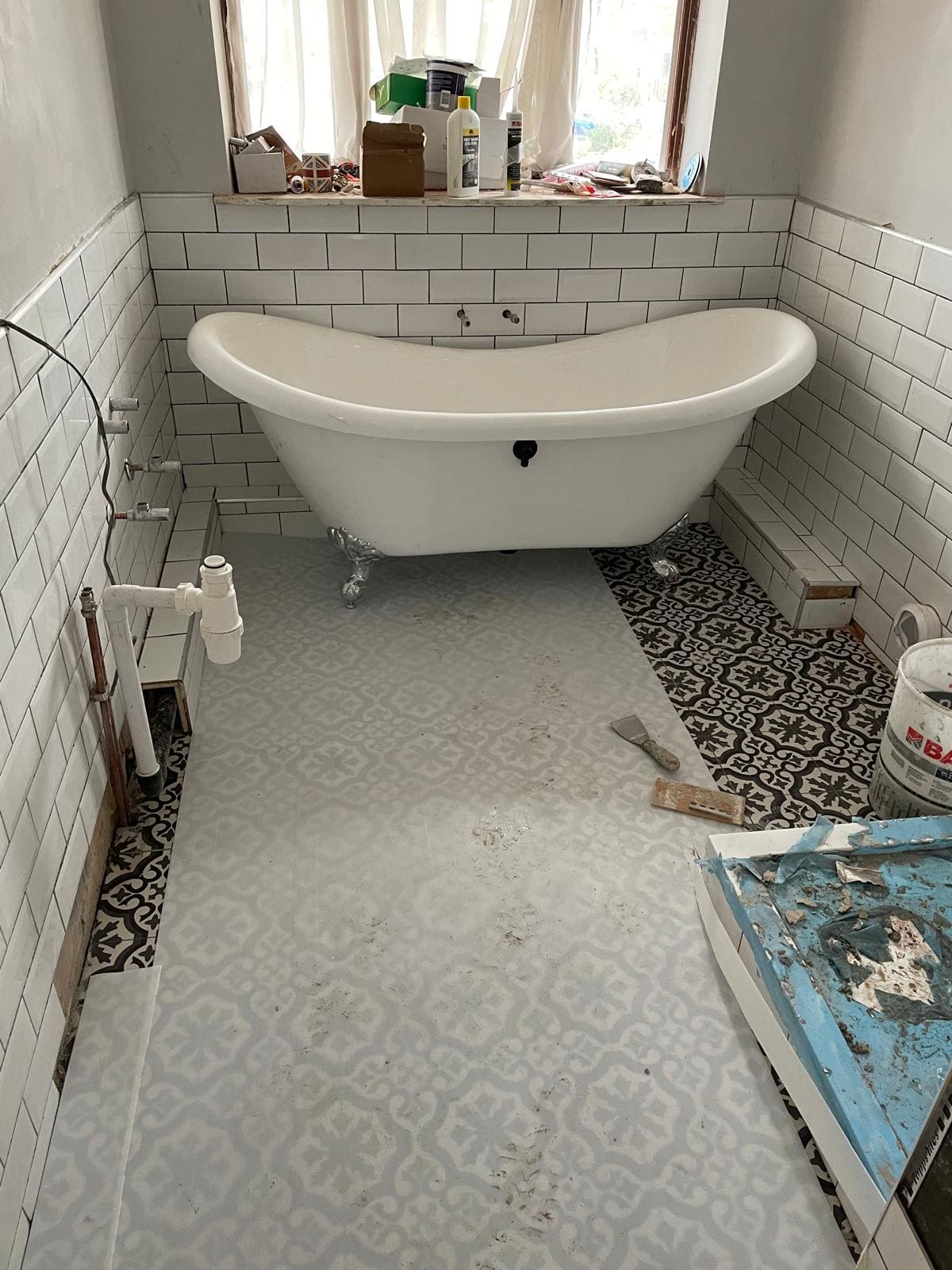 London bathroom refurbishment with freestanding bath, patterned floor tiles and new basin installation