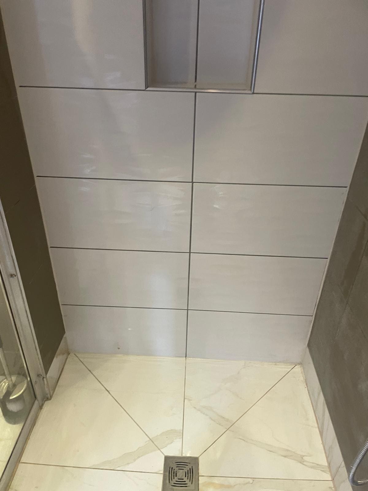 Bathroom installation in London showing tiling detail and fixture placement