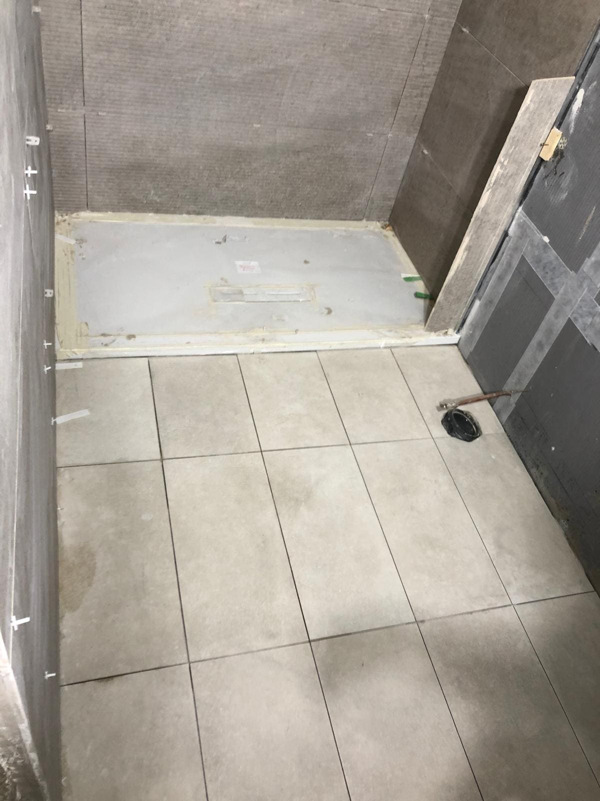 London bathroom project mid-tiling with new sanitaryware being fitted
