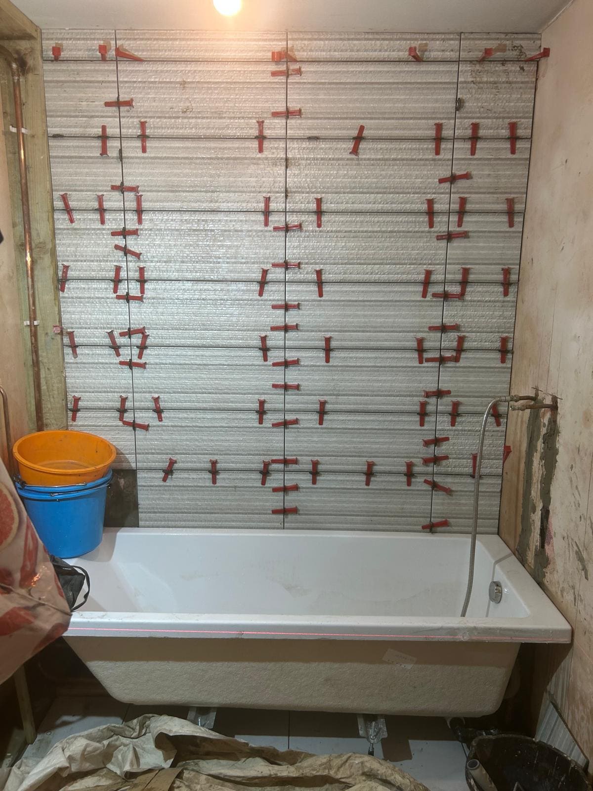 Bathroom project in London featuring new wall tiling and fixture installation