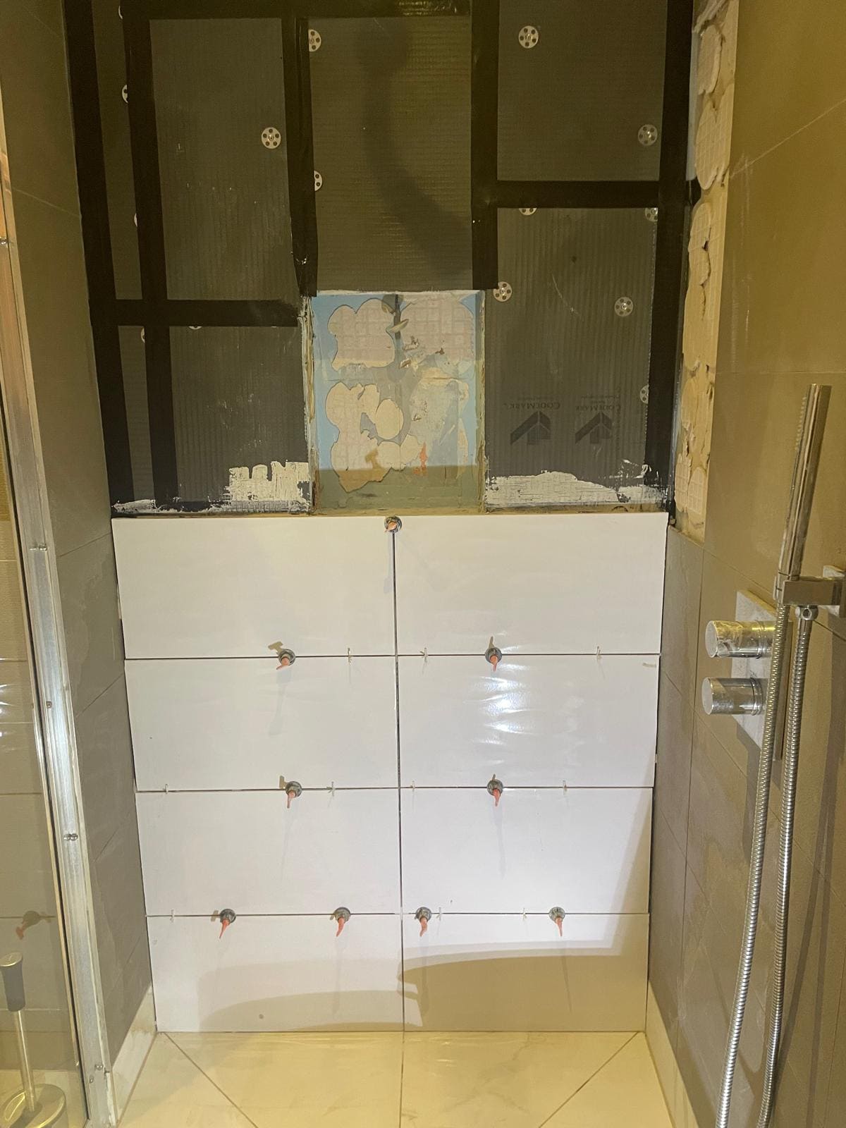 Bathroom refit in a London property with new tiled walls and floor